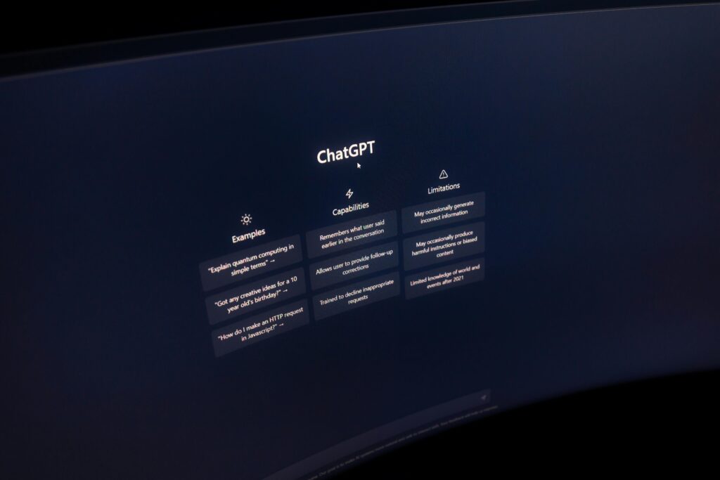 Close up of a computer screen displaying chatgpt interface in a dark setting.